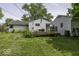 View of the house and detached garage from the yard, showcasing the home's outdoor space at 7702 Mary Ln, Indianapolis, IN 46217