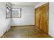 This empty bedroom offers wood floors, a closet, and a bright window at 7702 Mary Ln, Indianapolis, IN 46217