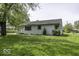 Quaint one story house with clean white siding and verdant front lawn at 7702 Mary Ln, Indianapolis, IN 46217