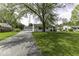 Charming single-story home with a well-manicured lawn and mature shade tree at 7702 Mary Ln, Indianapolis, IN 46217
