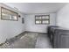 Functional laundry area features updated machines and natural light from a window at 7702 Mary Ln, Indianapolis, IN 46217