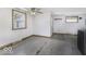 Room with two windows, concrete floors, and white walls at 7702 Mary Ln, Indianapolis, IN 46217