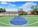A blue and green outdoor basketball court provides a recreational space, surrounded by fencing at 8120 Glenwillow Ln # 206, Indianapolis, IN 46278