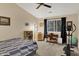 The bedroom includes a bed, desk, workout equipment and large window allowing ample natural light into the room at 8120 Glenwillow Ln # 206, Indianapolis, IN 46278