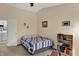 Guest bedroom furnished with a cozy bed, storage shelf, and easy access to laundry facilities, providing guest convenience at 8120 Glenwillow Ln # 206, Indianapolis, IN 46278