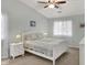 Inviting bedroom with vaulted ceilings, a ceiling fan, two side tables, and a matching white bed frame at 8120 Glenwillow Ln # 206, Indianapolis, IN 46278