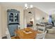 Open-concept dining area showcases a blue china cabinet, views to the bedroom, living room and table with chairs at 8120 Glenwillow Ln # 206, Indianapolis, IN 46278