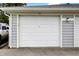 Well-kept two-car garage with a clean white door and neutral siding for a tidy appearance at 8120 Glenwillow Ln # 206, Indianapolis, IN 46278