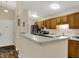 Kitchen with wooden cabinets, and a breakfast bar, offering both style and functionality at 8120 Glenwillow Ln # 206, Indianapolis, IN 46278
