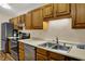 Well-equipped kitchen with stainless steel appliances, wooden cabinets, and ample storage at 8120 Glenwillow Ln # 206, Indianapolis, IN 46278