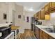 Bright kitchen featuring wood floors, stainless steel appliances, and ample counter space at 8120 Glenwillow Ln # 206, Indianapolis, IN 46278