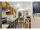 Efficient kitchen featuring wood cabinets, stainless steel appliances, and a convenient layout for cooking and dining at 8120 Glenwillow Ln # 206, Indianapolis, IN 46278
