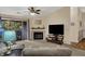 Cozy living room with a fireplace, sliding glass doors to the patio and a ceiling fan for relaxation and entertainment at 8120 Glenwillow Ln # 206, Indianapolis, IN 46278