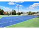 Outdoor tennis court with blue and green surface, ready for a match on a sunny day at 8120 Glenwillow Ln # 206, Indianapolis, IN 46278