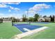 Well-maintained tennis courts offer a recreational amenity with lush landscaping in a residential area at 8120 Glenwillow Ln # 206, Indianapolis, IN 46278