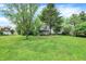 Spacious backyard with a lush lawn and scenic views of the home's deck at 831 Wakulla Ct, Indianapolis, IN 46217