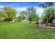 Expansive backyard with green lawn, storage sheds, and partially-covered patio area at 831 Wakulla Ct, Indianapolis, IN 46217