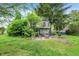 Spacious backyard featuring a patio area with seating and mature trees at 831 Wakulla Ct, Indianapolis, IN 46217
