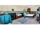 Basement area with twin bed, shelving, carpet and green and neutral colored walls at 831 Wakulla Ct, Indianapolis, IN 46217