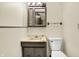 Cozy bathroom featuring a decorative vanity and sink with a mirrored medicine cabinet at 831 Wakulla Ct, Indianapolis, IN 46217