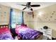 Bedroom boasts butterfly and sports themed decor, beds, and a window at 831 Wakulla Ct, Indianapolis, IN 46217