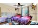 This bedroom features colorful decor, and beds with purple and pink covers at 831 Wakulla Ct, Indianapolis, IN 46217