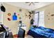 Bedroom boasts sports-themed wall decor, window with curtain and hardwood floors at 831 Wakulla Ct, Indianapolis, IN 46217
