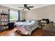This bedroom features hardwood floors, a ceiling fan, and a window for natural light at 831 Wakulla Ct, Indianapolis, IN 46217