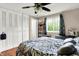 Bedroom features a ceiling fan, closet, window, and hardwood floors at 831 Wakulla Ct, Indianapolis, IN 46217