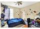 This bedroom features blue bedding, sports themed decor, and hardwood floors at 831 Wakulla Ct, Indianapolis, IN 46217