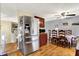 Stainless steel refrigerator and dining area featuring hardwood floors and natural light at 831 Wakulla Ct, Indianapolis, IN 46217