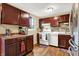 Bright kitchen featuring wood floors, matching brown cabinets, white appliances, and a decorative backsplash at 831 Wakulla Ct, Indianapolis, IN 46217