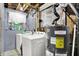 Functional laundry room area featuring a washer, dryer, and water heater at 831 Wakulla Ct, Indianapolis, IN 46217