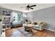 Comfortable living room featuring a sofa, hardwood floors, and large window at 831 Wakulla Ct, Indianapolis, IN 46217