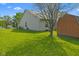 Exterior showcasing a large backyard with lush lawn and storage shed by the side of the home at 8451 Sunningdale Blvd, Indianapolis, IN 46234