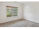 Bright bedroom with a window, neutral carpet, and fresh white walls at 8451 Sunningdale Blvd, Indianapolis, IN 46234