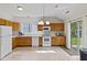 Bright kitchen featuring ample oak cabinetry, modern appliances, and sliding glass doors at 8451 Sunningdale Blvd, Indianapolis, IN 46234
