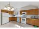 Functional kitchen featuring oak cabinets, white countertops, and modern appliances under ample lighting at 8451 Sunningdale Blvd, Indianapolis, IN 46234