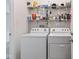 Laundry room featuring a washer, dryer, and storage shelving at 8451 Sunningdale Blvd, Indianapolis, IN 46234