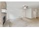 Bright living room with fireplace, ceiling fan, and neutral carpet flooring at 8451 Sunningdale Blvd, Indianapolis, IN 46234