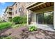 Back patio area with a sliding glass door and green plants at 8720 Yardley Ct # 100, Indianapolis, IN 46268