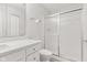 Well-lit bathroom with white vanity, toilet, and shower with glass doors at 8720 Yardley Ct # 100, Indianapolis, IN 46268