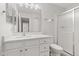 Bright bathroom featuring a shower, white vanity, toilet, and large mirror at 8720 Yardley Ct # 100, Indianapolis, IN 46268