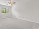 Bright carpeted bedroom with a ceiling fan and window with view of the outside at 8720 Yardley Ct # 100, Indianapolis, IN 46268