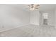 Bright carpeted bedroom with a ceiling fan and a large closet space and window with view of the outside at 8720 Yardley Ct # 100, Indianapolis, IN 46268