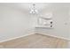 Well-lit dining area with a chandelier and view to a white kitchen, combining style and convenience at 8720 Yardley Ct # 100, Indianapolis, IN 46268