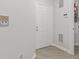 Bright entryway with a white door and light-colored flooring, showcasing a clean design at 8720 Yardley Ct # 100, Indianapolis, IN 46268