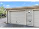 Close up view of garage doors numbered 14 with beige painted siding at 8720 Yardley Ct # 100, Indianapolis, IN 46268