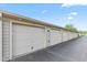 Street view of multiple garages numbered from 14 and up with beige siding at 8720 Yardley Ct # 100, Indianapolis, IN 46268