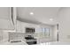Kitchen boasts stainless appliances, white cabinets, quartz countertops and view out the window at 8720 Yardley Ct # 100, Indianapolis, IN 46268
